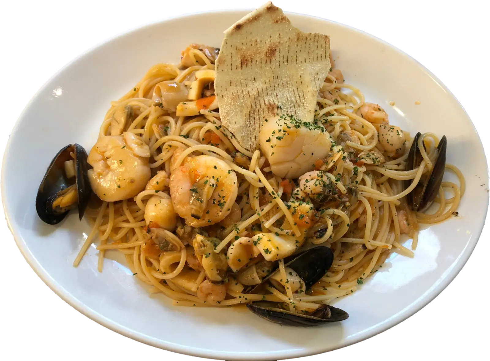 A plate of spaghetti with mussels, prawns, scallops and squid, topped with a crisp flatbread, from Fabio's kitchen